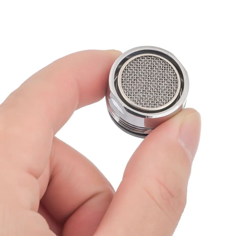 Person holding small silver metal device.