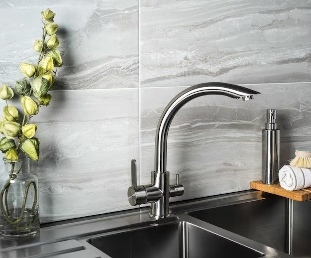 Modern kitchen sink with faucet and vase.