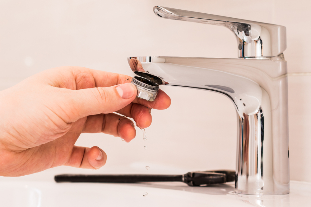fixing faucet to clean clogged aerator.
